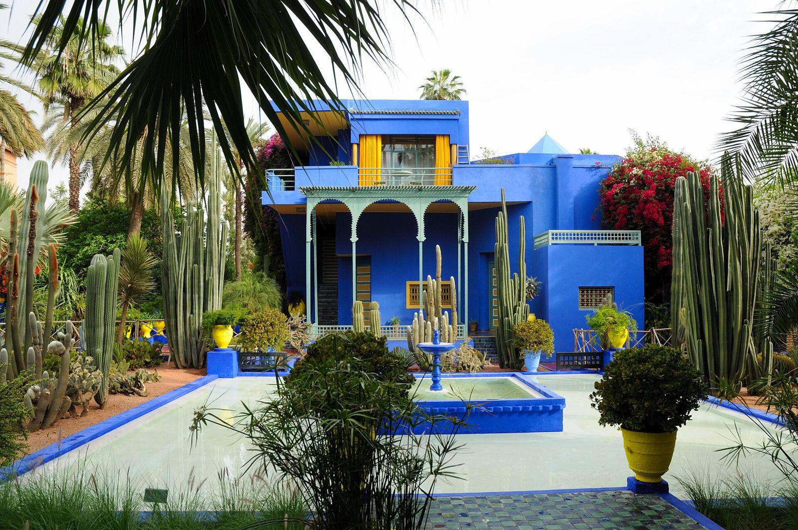 The cobalt blue villa of the Jardin Majorelle in Marrakech surrounded by cacti and palms