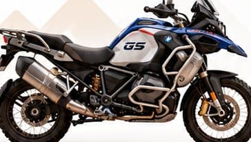 Large white, blue and red BMW GS adventure motorcycle seen from the side